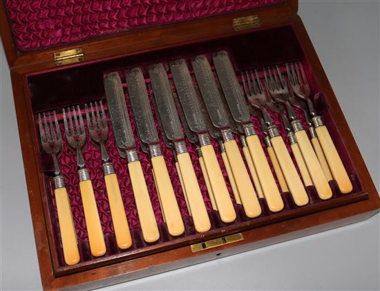 A cased set of twelve pairs of ivory handled plated fish eaters,